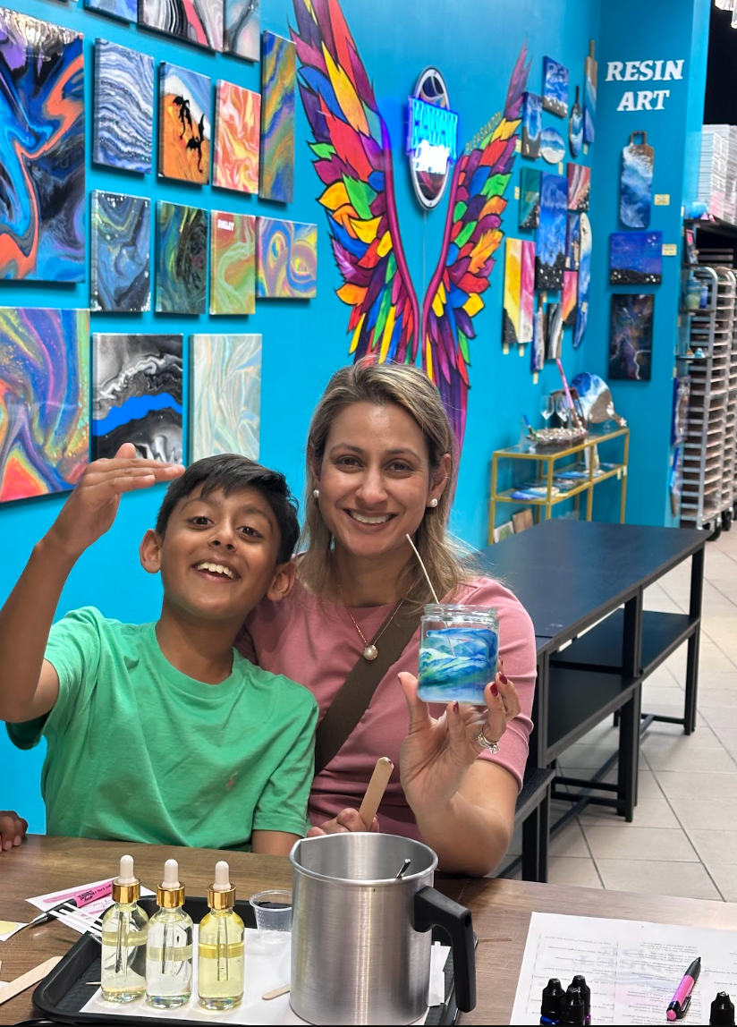 Mother and son holding a handmade Sunset Tide candle at Makers Art Studio Pleasanton