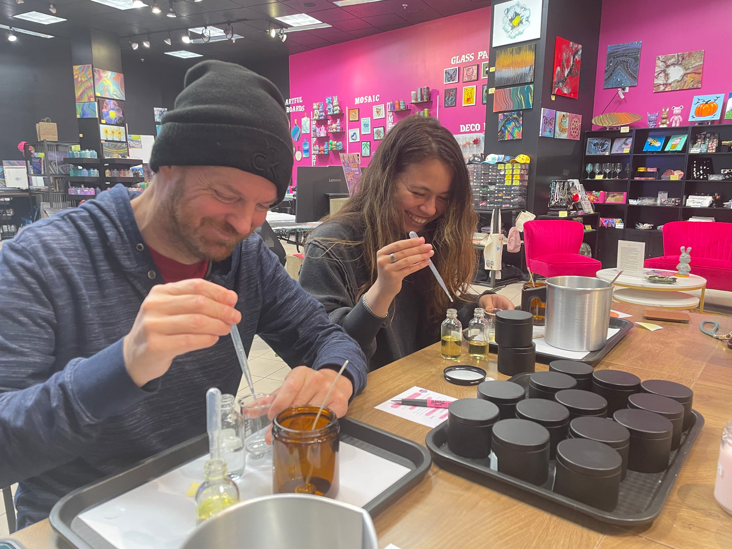 Dad and guest laughing while blending fragrances at Dad's Candle Bar in Pleasanton