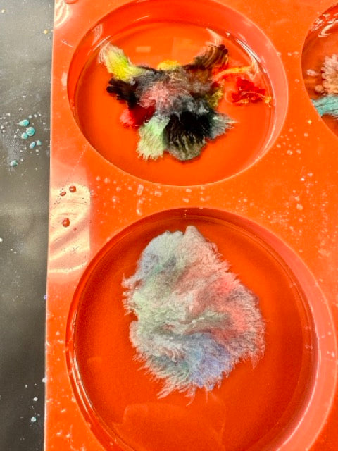 Resin coasters curing in molds