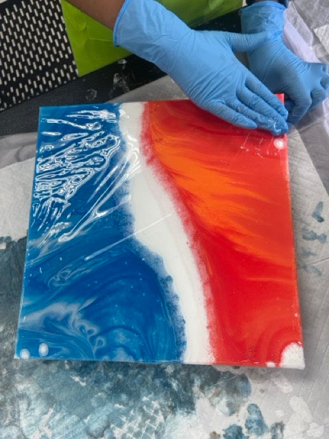 A vibrant fluid art canvas in progress